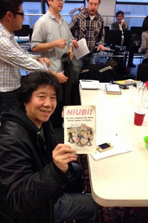 Meng Jingui holding a copy of Niubi by Eveline Chao - photograph by Nick Frisch